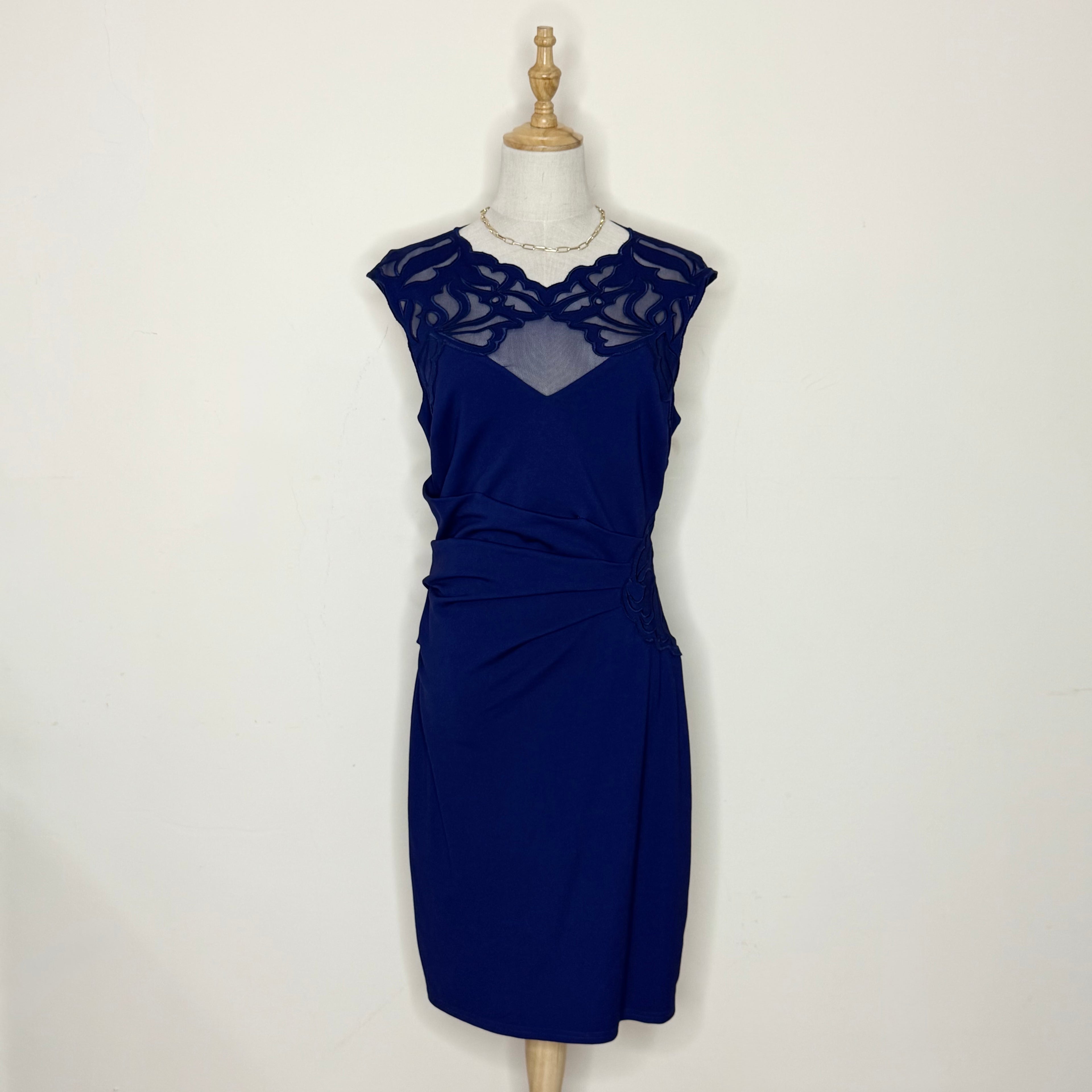 Navy blue dress on a mannequin against a white background