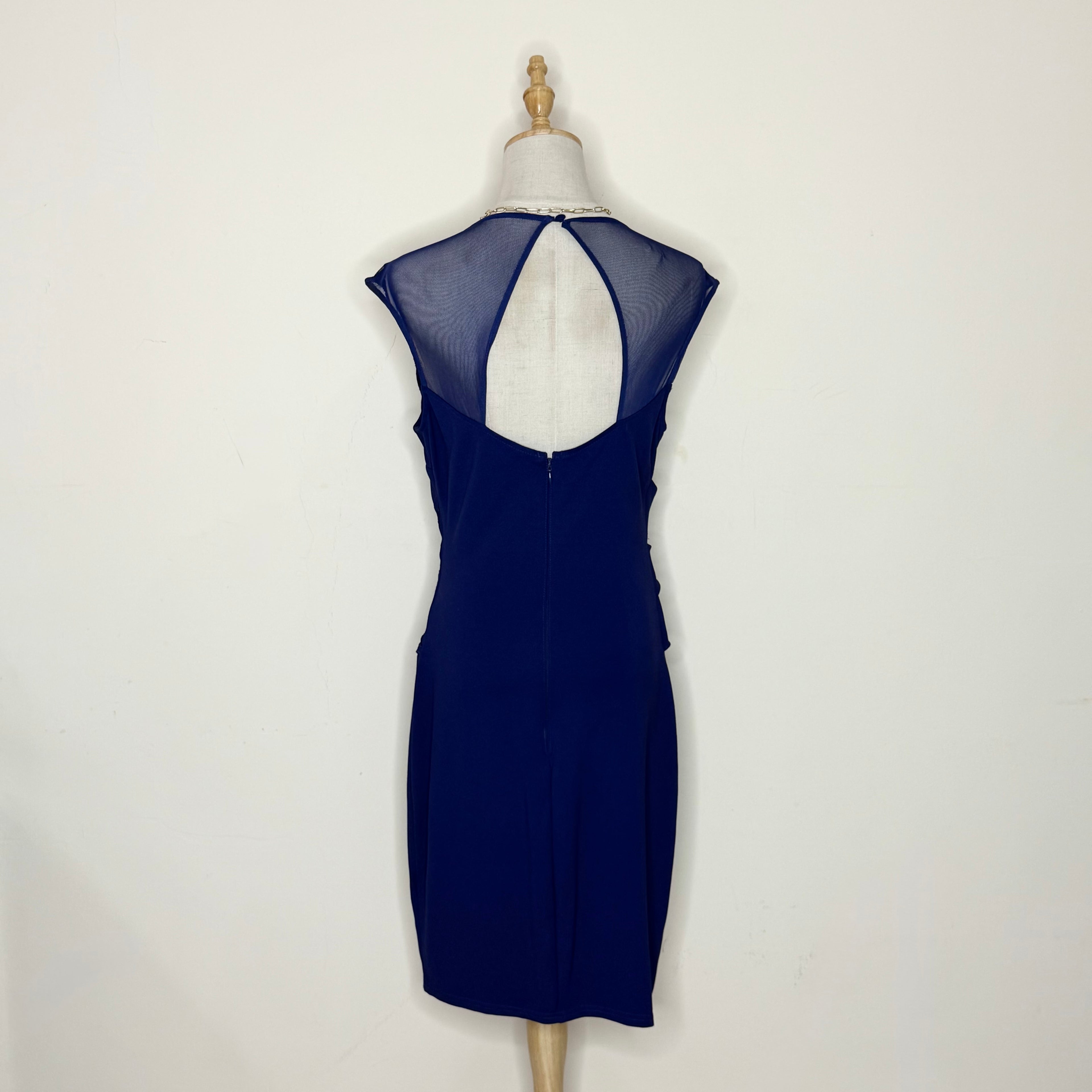 Navy blue dress on a mannequin against a white background
