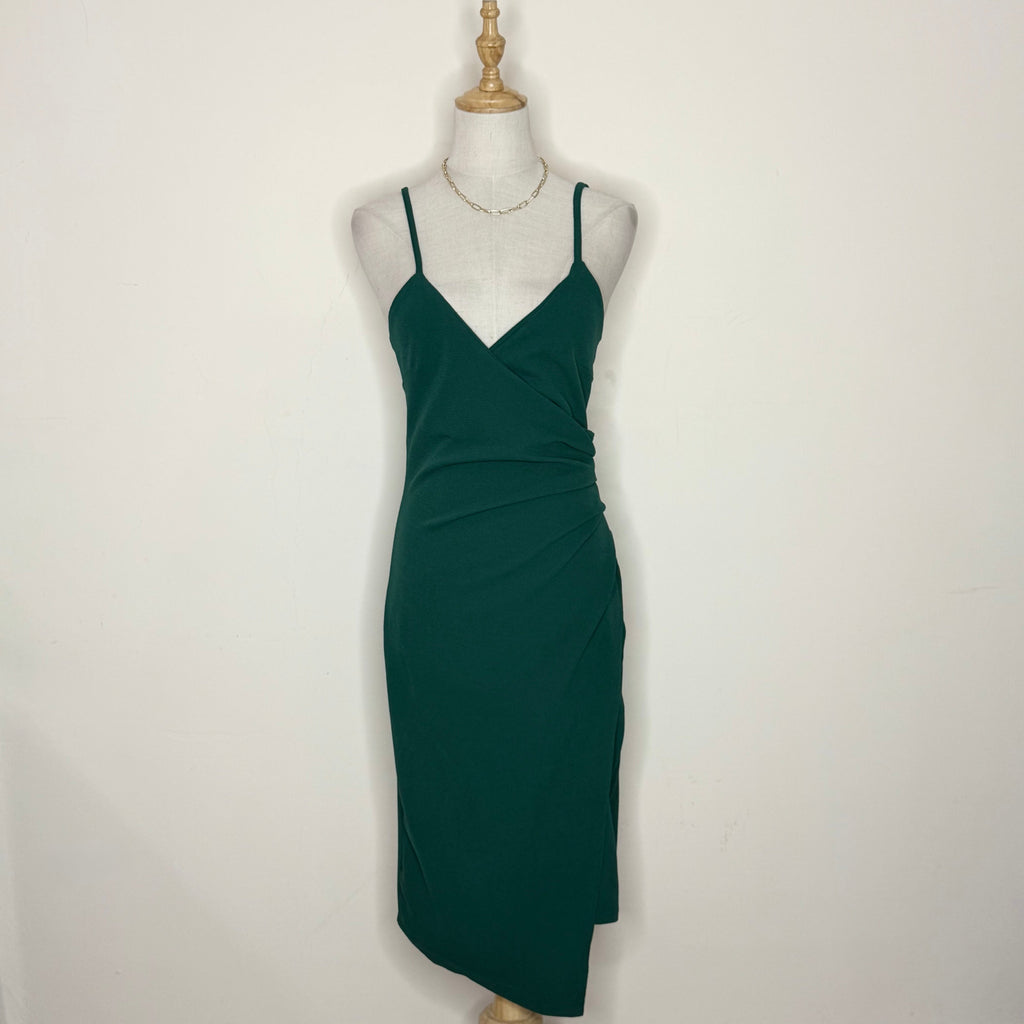 Green dress on a mannequin against a white background