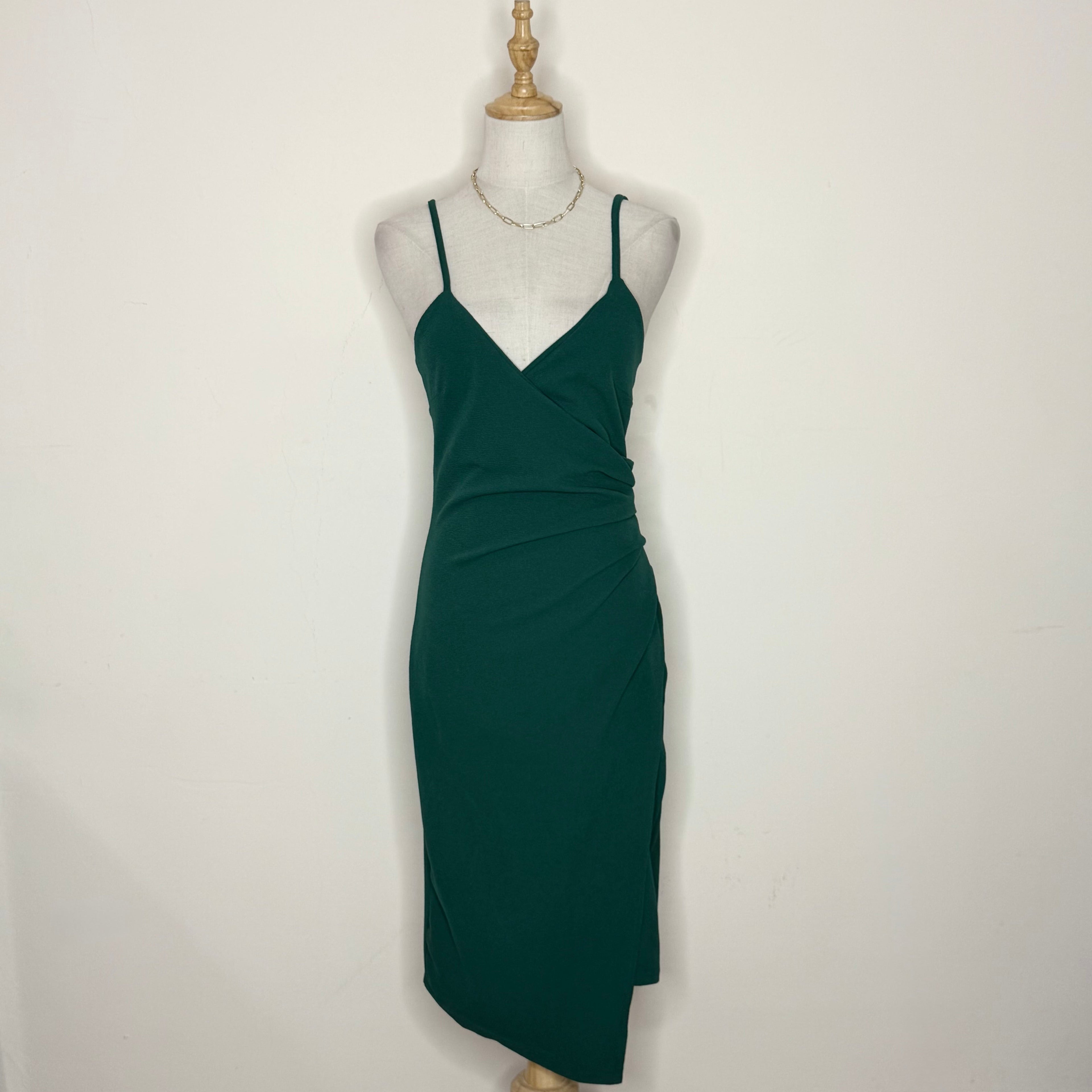 Green dress on a mannequin against a white background