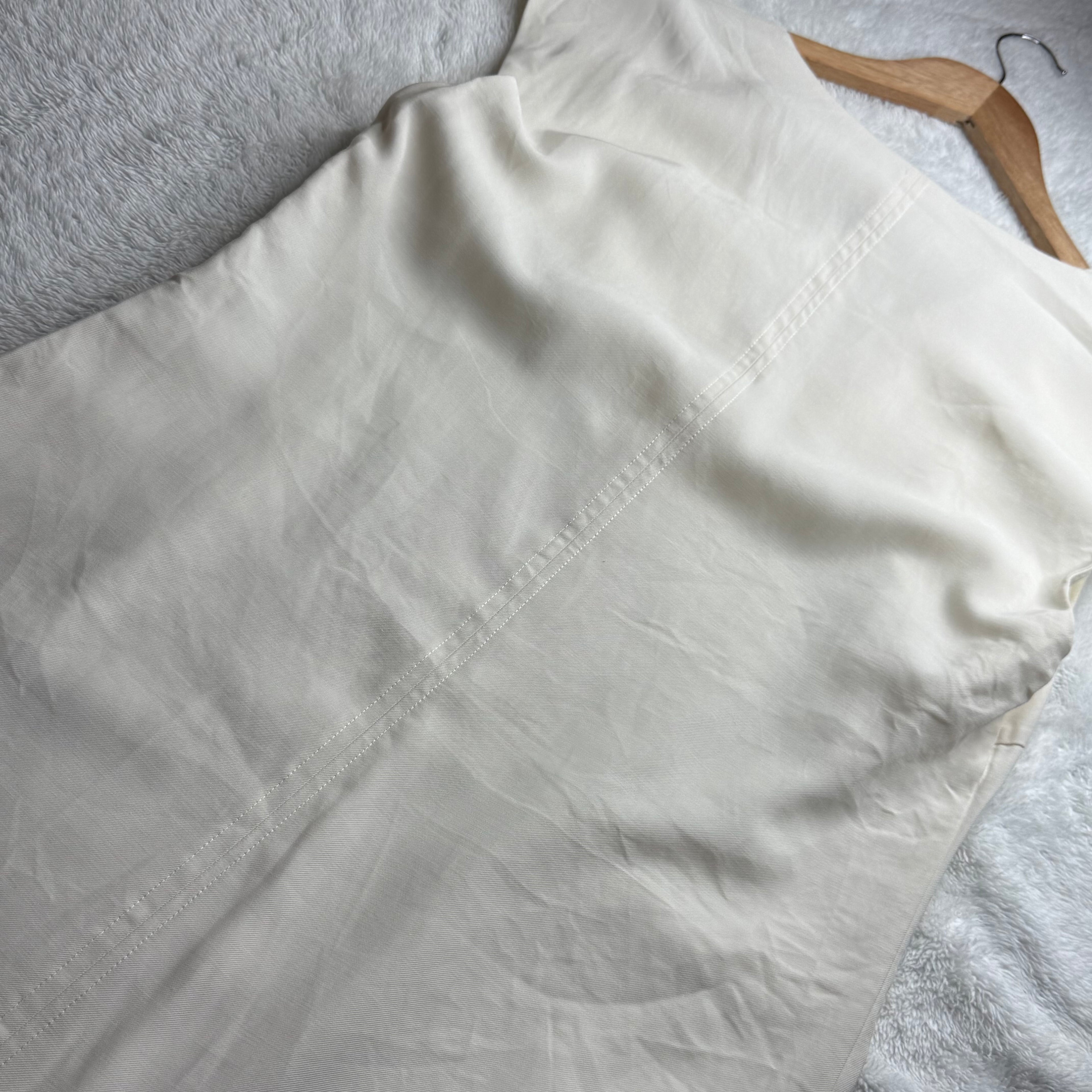 White shirt on a hanger with a white background