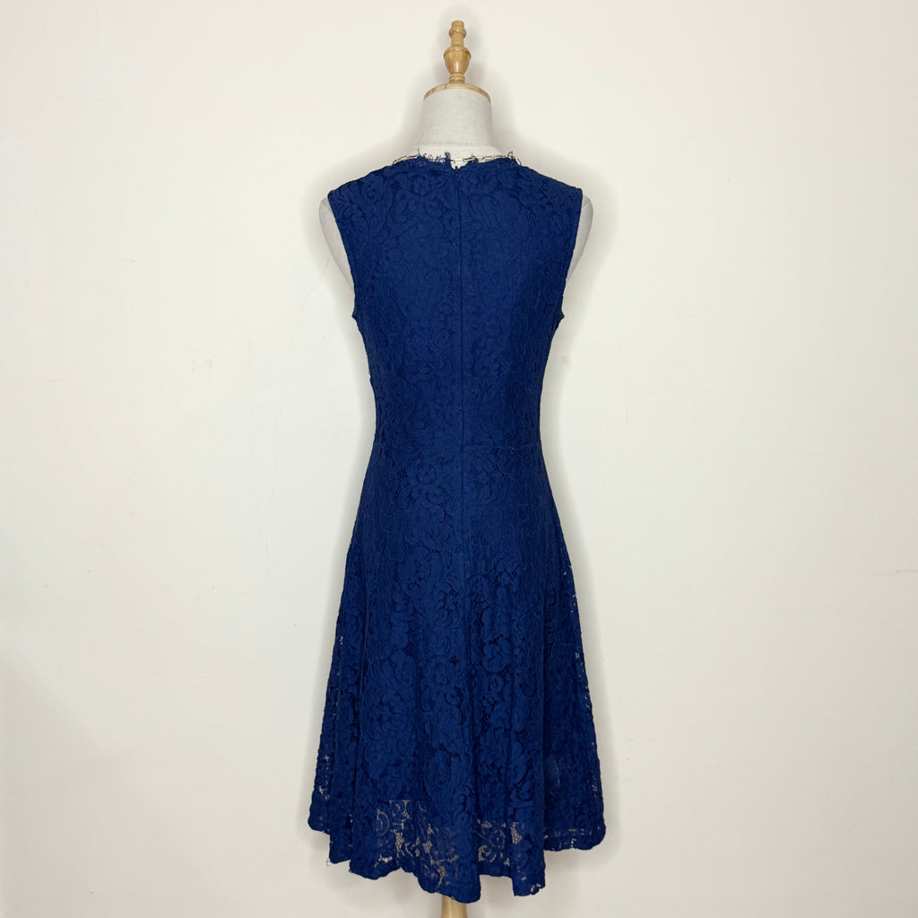 Navy blue lace dress on a mannequin against a white background