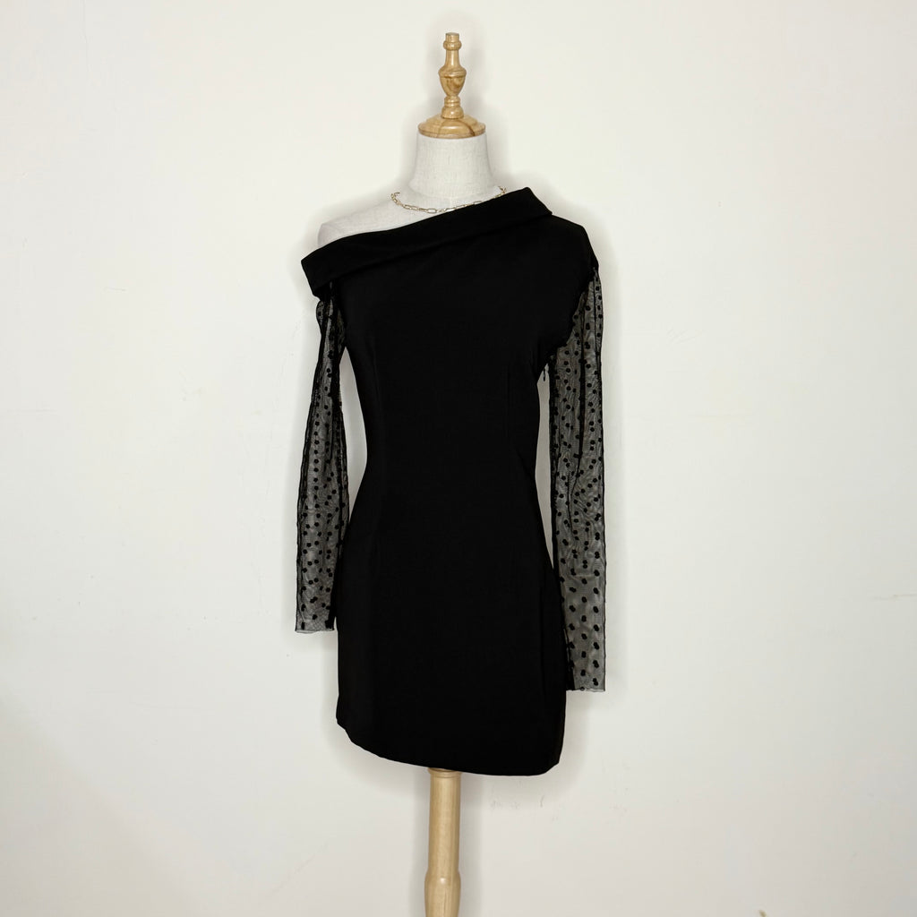 Black dress with sheer sleeves on a mannequin against a white background