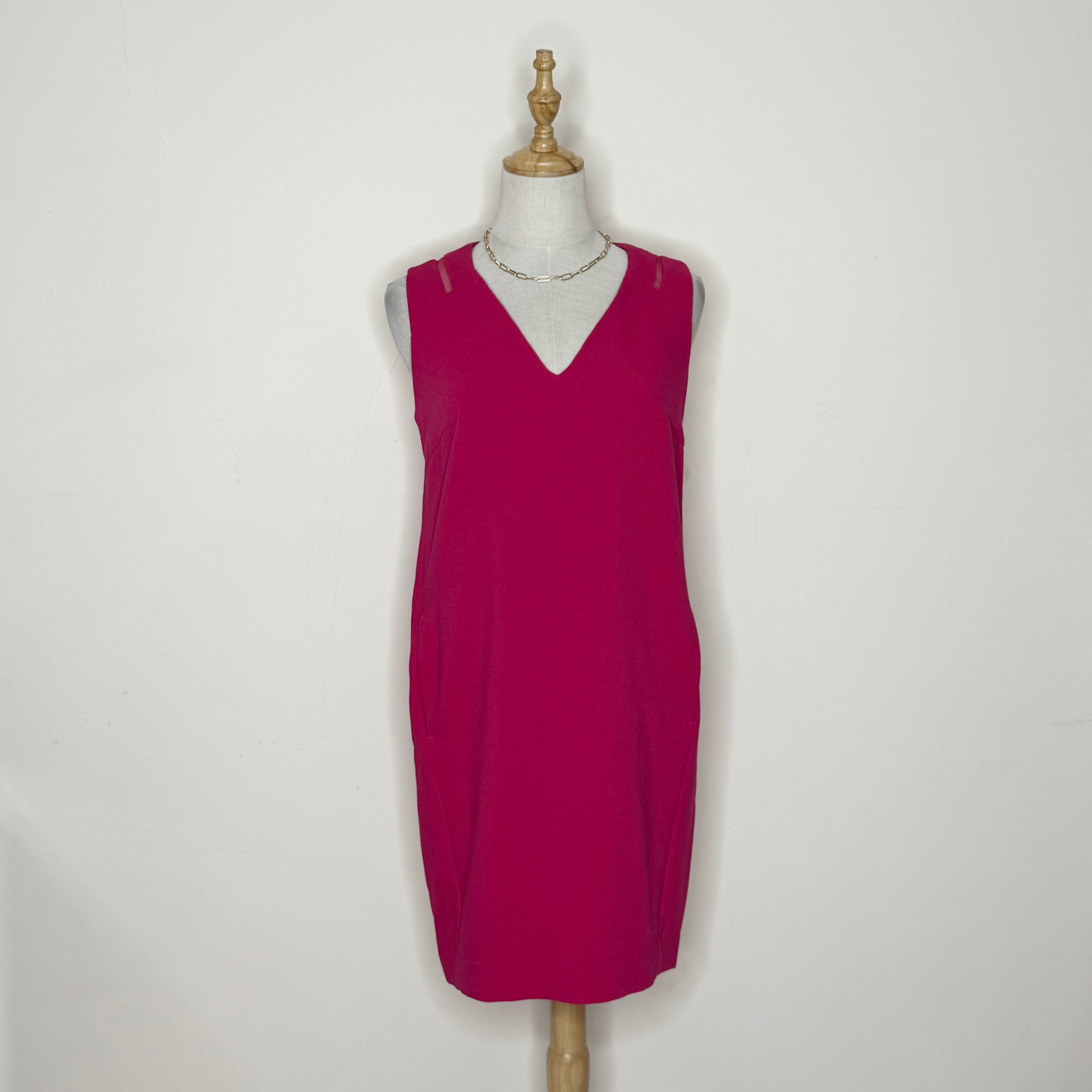 Red dress on a mannequin against a white background