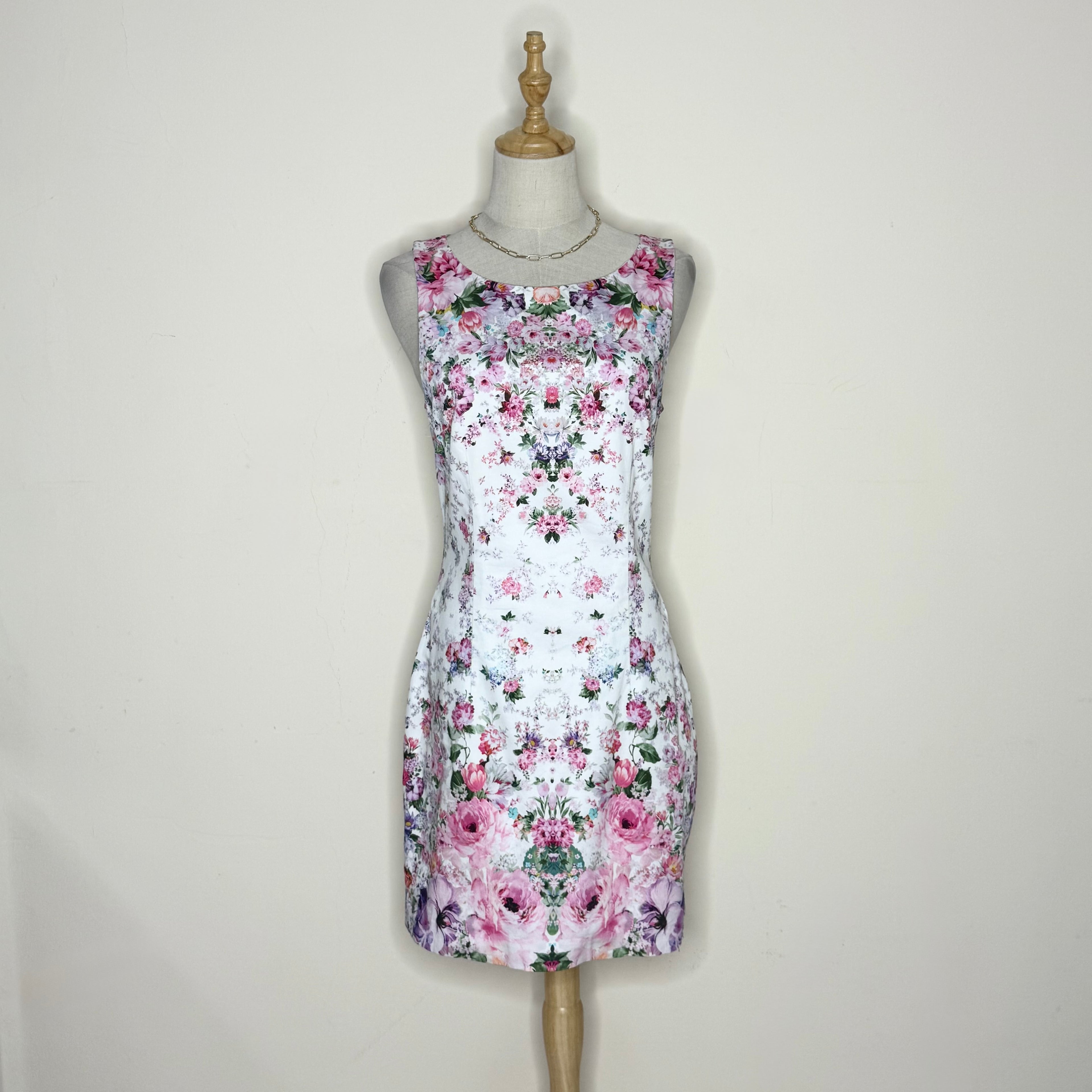 Floral dress on a mannequin against a plain background