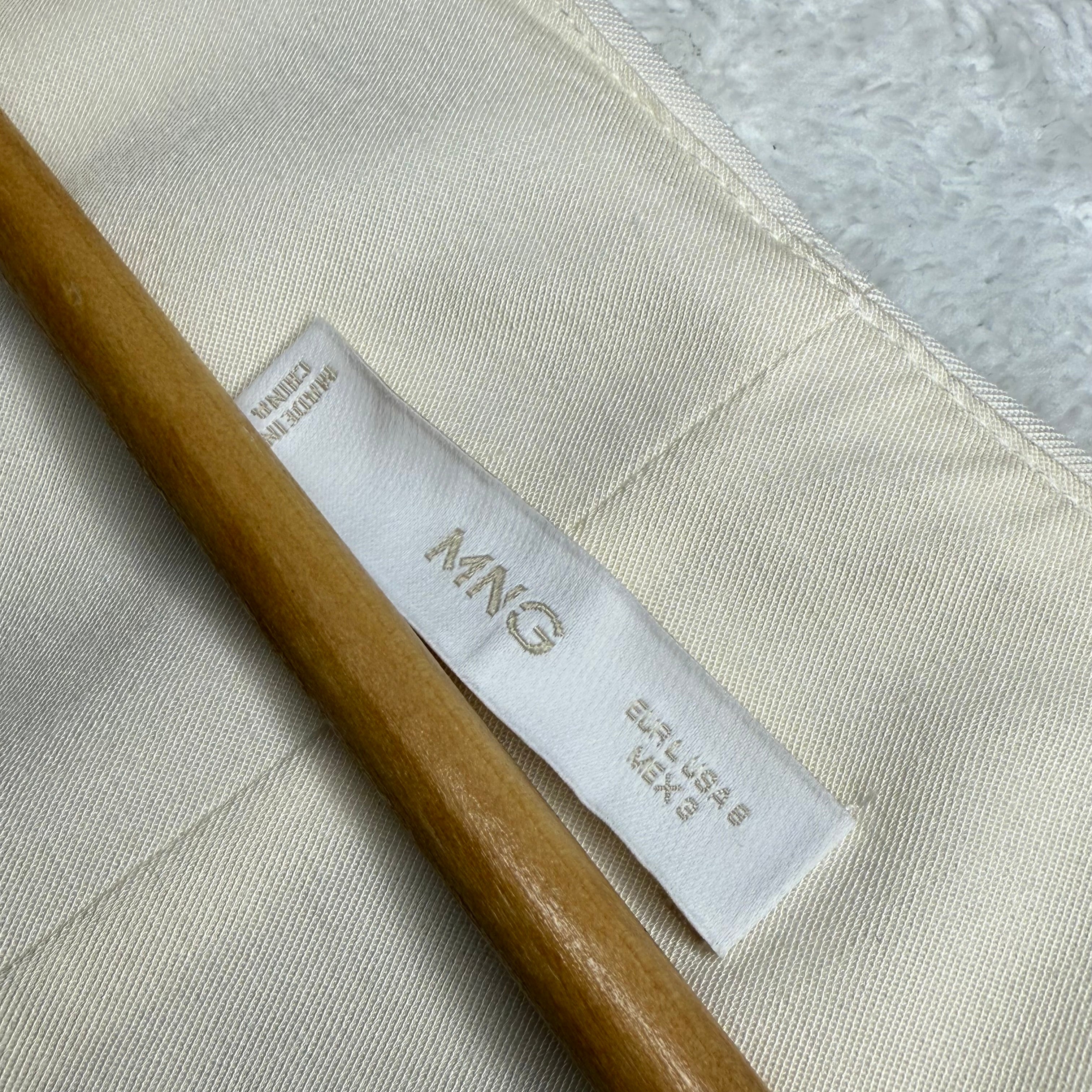 Label with 'MNG' branding on a fabric background